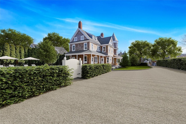 30 Huntting Ln, East Hampton, NY 11937 - view of home's exterior with a chimney and fence