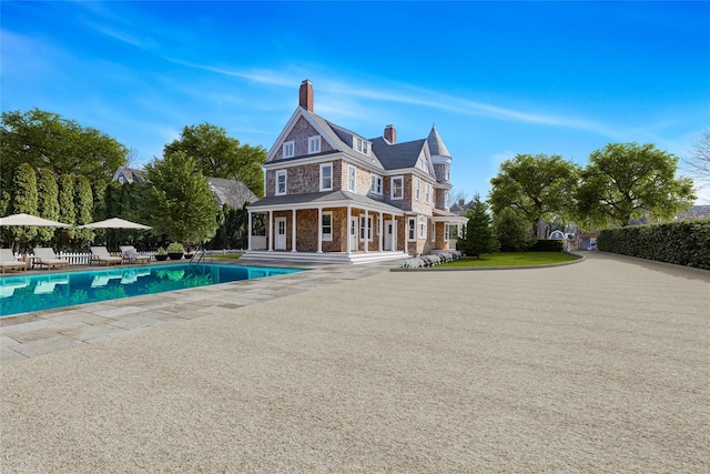 30 Huntting Ln, East Hampton, NY 11937 - back of house featuring a patio area and a chimney