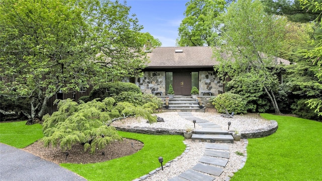 4 Bobby Close, Mamaroneck, NY 10543 - view of front facade with stone siding, a front lawn, and a shingled roof