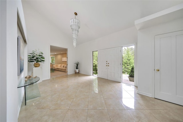 4 Bobby Close, Mamaroneck, NY 10543 - foyer featuring plenty of natural light, high vaulted ceiling, baseboards, and light tile patterned floors