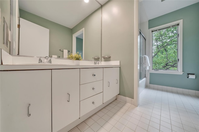 4 Bobby Close, Mamaroneck, NY 10543 - bathroom featuring double vanity, tile patterned flooring, combined bath / shower with glass door, and baseboards