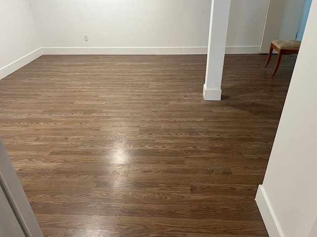 1963 Central Dr N, East Meadow, NY 11554 - basement with dark wood-style floors and baseboards