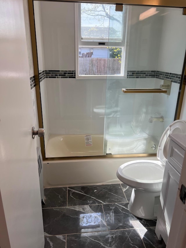 1963 Central Dr N, East Meadow, NY 11554 - bathroom with enclosed tub / shower combo, toilet, and marble finish floors