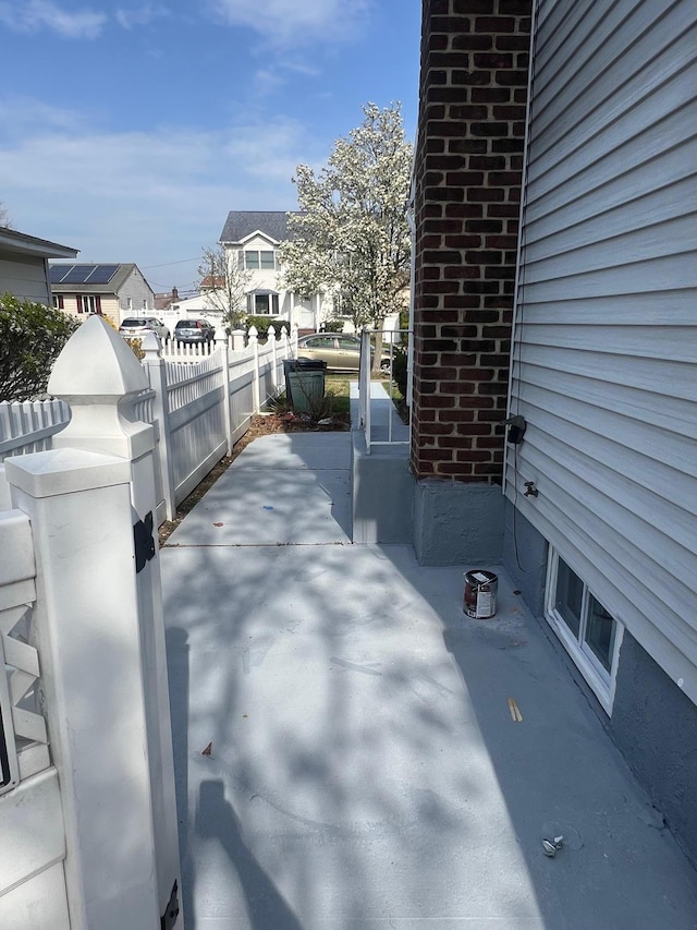 1963 Central Dr N, East Meadow, NY 11554 - view of patio / terrace featuring fence and a residential view
