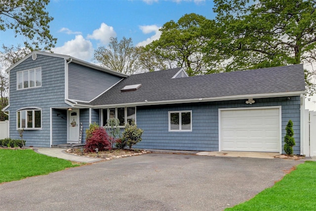 11 Mallard Ave, Selden, NY 11784 - view of front of house featuring a garage, asphalt driveway, and roof with shingles