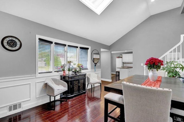 11 Mallard Ave, Selden, NY 11784 - dining area featuring vaulted ceiling, dark wood finished floors, wainscoting, stairs, and a skylight