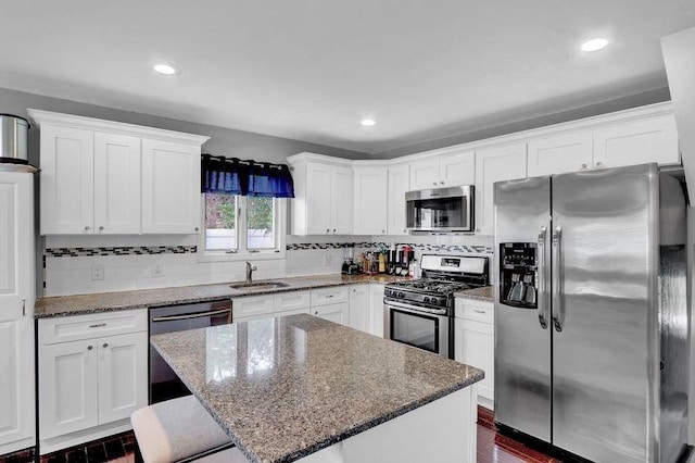 11 Mallard Ave, Selden, NY 11784 - kitchen with stainless steel appliances, a sink, white cabinets, a center island, and tasteful backsplash