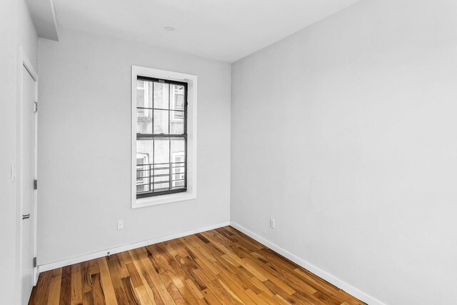 34-21 9th St, Astoria, NY 11106 - unfurnished room featuring baseboards and wood finished floors