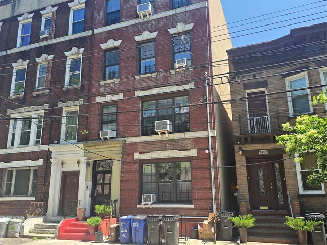34-21 9th St, Astoria, NY 11106 - view of front of property featuring brick siding and cooling unit