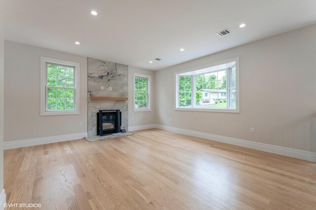 6 Reina Ct, Valley Cottage, NY 10989 - unfurnished living room with light wood finished floors, baseboards, a high end fireplace, and recessed lighting