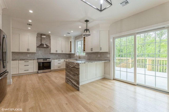 6 Reina Ct, Valley Cottage, NY 10989 - kitchen with wall chimney range hood, appliances with stainless steel finishes, a peninsula, tasteful backsplash, and a sink