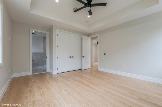 6 Reina Ct, Valley Cottage, NY 10989 - unfurnished bedroom featuring a tray ceiling, light wood-type flooring, baseboards, recessed lighting, and a closet