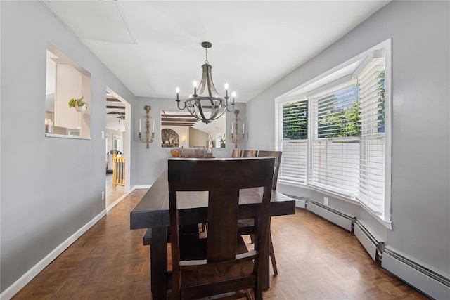 979 Manor Ln, Bay Shore, NY 11706 - dining space featuring a chandelier, baseboards, and a baseboard heating unit
