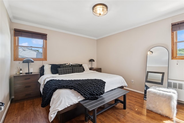 979 Manor Ln, Bay Shore, NY 11706 - bedroom featuring radiator heating unit, wood finished floors, baseboards, and ornamental molding