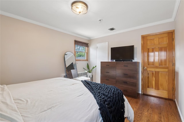 979 Manor Ln, Bay Shore, NY 11706 - bedroom featuring crown molding, wood finished floors, and radiator heating unit