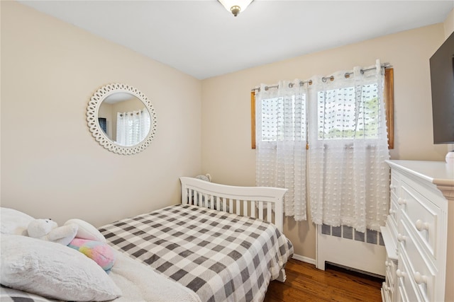 979 Manor Ln, Bay Shore, NY 11706 - bedroom with radiator, dark wood-type flooring, and baseboards