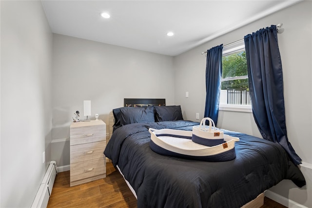 979 Manor Ln, Bay Shore, NY 11706 - bedroom with a baseboard radiator, wood finished floors, baseboards, and recessed lighting