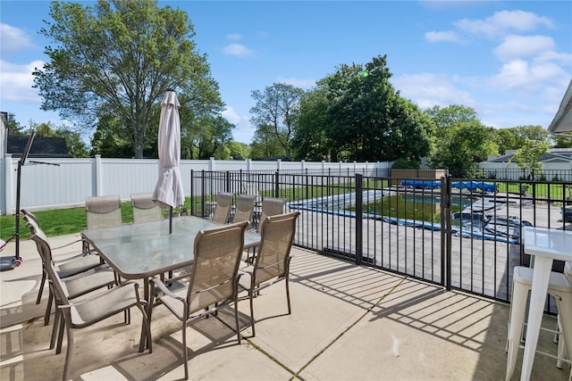 979 Manor Ln, Bay Shore, NY 11706 - fenced backyard featuring outdoor dining space and a patio area