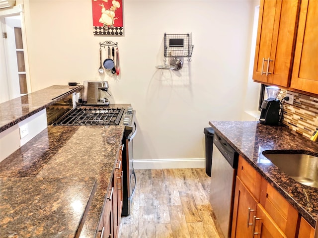 118-60 Metropolitan Ave Unit 6F, Kew Gardens, NY 11415 - kitchen featuring stainless steel appliances, brown cabinetry, backsplash, baseboards, and light wood-style floors