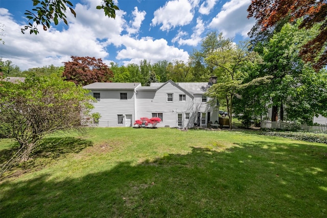 19 Reynal Rd, White Plains, NY 10605 - back of property with a chimney and view of wooded area