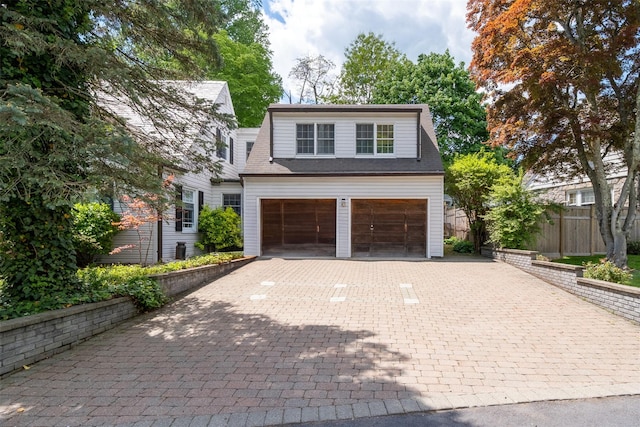 19 Reynal Rd, White Plains, NY 10605 - view of front of house with decorative driveway, fence, and an attached garage