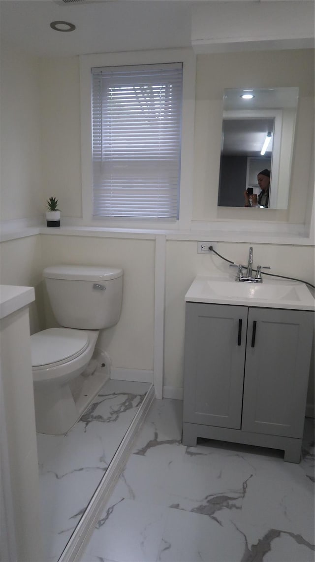 21 Hammond St, Monticello, NY 12701 - bathroom with vanity, toilet, and marble look tile flooring