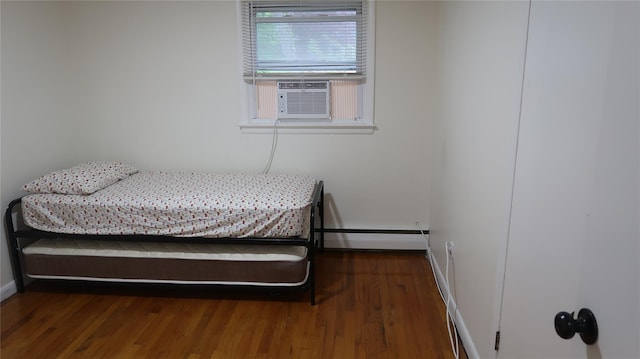 21 Hammond St, Monticello, NY 12701 - bedroom with a baseboard heating unit, wood finished floors, and baseboards