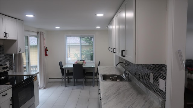 21 Hammond St, Monticello, NY 12701 - kitchen featuring electric stove, a sink, decorative backsplash, recessed lighting, and white cabinets