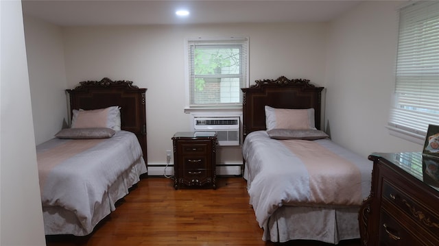 21 Hammond St, Monticello, NY 12701 - bedroom with wood finished floors, a baseboard heating unit, and recessed lighting