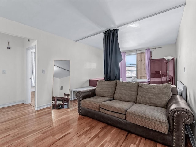 living room featuring light wood finished floors and baseboards