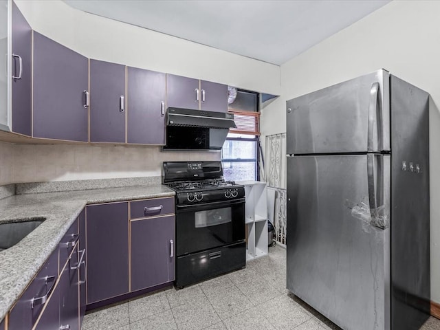 kitchen featuring freestanding refrigerator, black range with gas cooktop, granite floors, and blue cabinetry