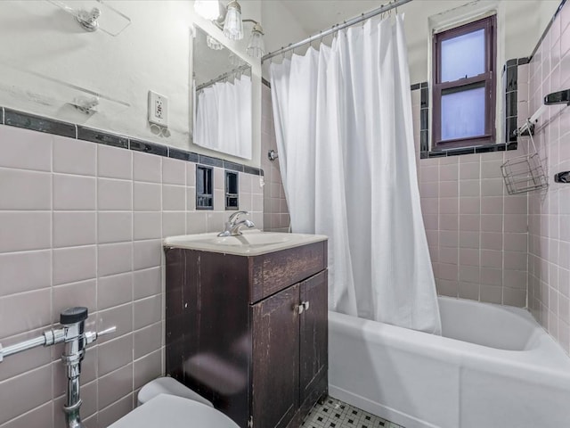 full bathroom featuring tile walls, shower / tub combo with curtain, toilet, and vanity