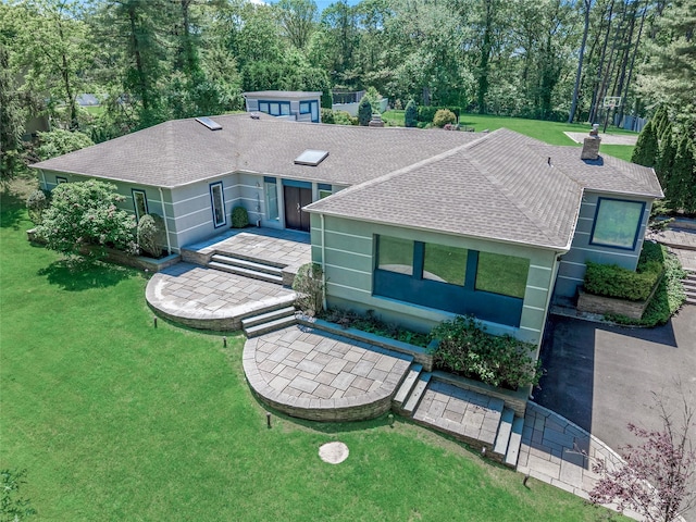 11 Faulkner Ln, Dix Hills, NY 11746 - ranch-style house featuring roof with shingles, a patio, a chimney, and a front lawn