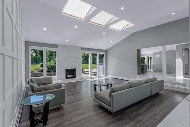 11 Faulkner Ln, Dix Hills, NY 11746 - living room with a baseboard heating unit, a large fireplace, high vaulted ceiling, recessed lighting, and baseboards