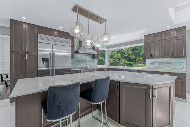 11 Faulkner Ln, Dix Hills, NY 11746 - kitchen with stainless steel built in refrigerator, tasteful backsplash, recessed lighting, a spacious island, and light stone countertops
