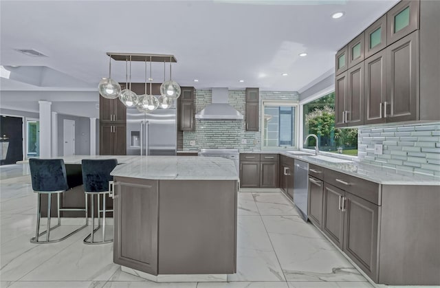 11 Faulkner Ln, Dix Hills, NY 11746 - kitchen with stainless steel appliances, wall chimney exhaust hood, light marble finish floors, a kitchen island, and recessed lighting