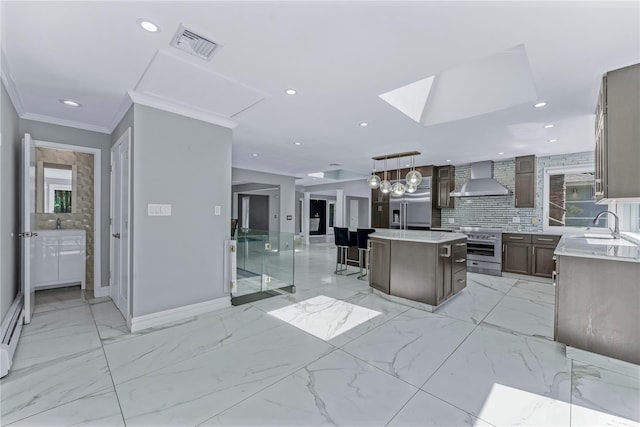 11 Faulkner Ln, Dix Hills, NY 11746 - kitchen with wall chimney exhaust hood, high end appliances, a sink, a kitchen island, and baseboards
