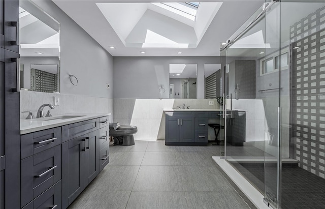 11 Faulkner Ln, Dix Hills, NY 11746 - full bath with a skylight, a shower stall, tile walls, two vanities, and toilet