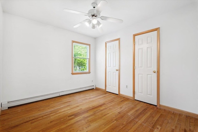 unfurnished bedroom with a baseboard heating unit, light wood-style flooring, baseboards, and ceiling fan