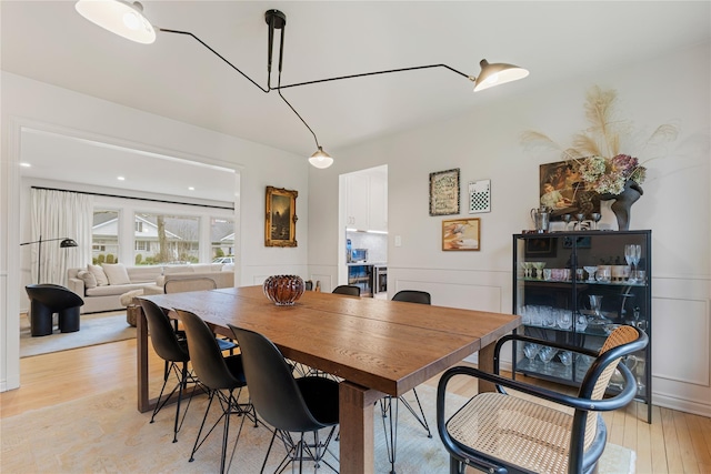 dining space featuring light wood finished floors
