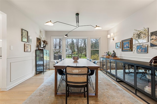 dining space featuring light wood-style floors