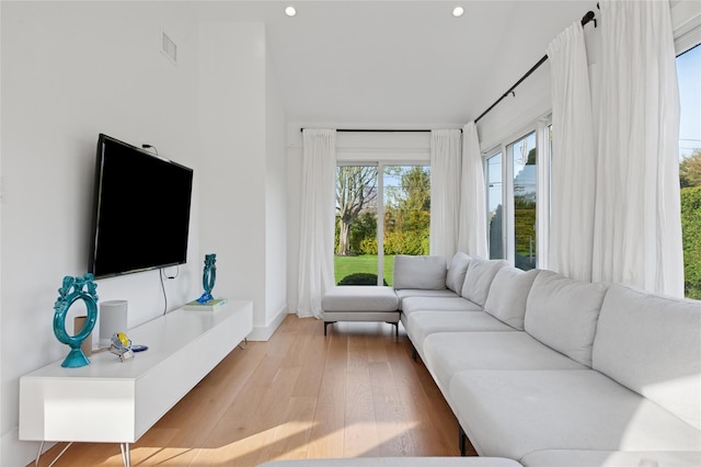 living area with light wood-style floors, recessed lighting, and baseboards