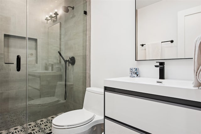 bathroom with toilet, vanity, and a stall shower