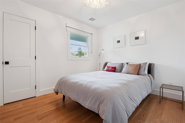 bedroom featuring light wood-style flooring and baseboards