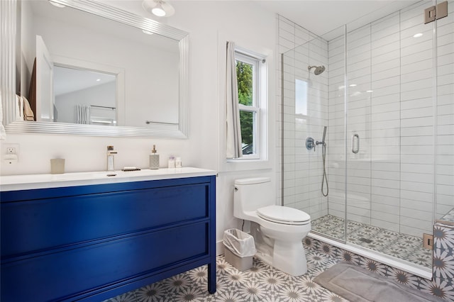 bathroom with toilet, a stall shower, vanity, and tile patterned flooring