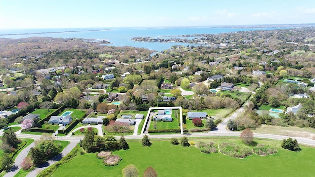 aerial view of residential area with a nearby body of water and property boundaries highlighted