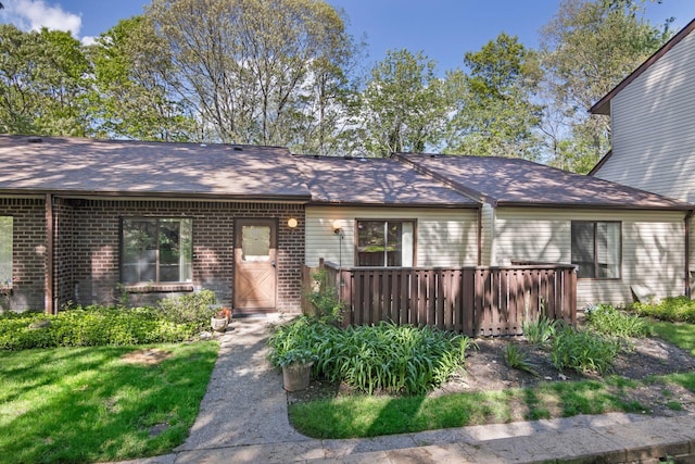 115 Birchwood Rd, Coram, NY 11727 - view of front of house with a deck, brick siding, and a shingled roof