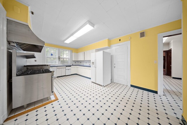 10-08 Shore Rd, Douglaston, NY 11363 - kitchen featuring white appliances, light flooring, range hood, and white cabinets