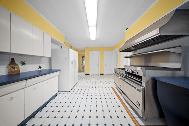 10-08 Shore Rd, Douglaston, NY 11363 - kitchen featuring white fridge with ice dispenser, white cabinets, dark countertops, light floors, and wall chimney range hood