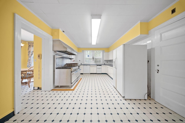 10-08 Shore Rd, Douglaston, NY 11363 - kitchen with white appliances, white cabinets, premium range hood, light floors, and crown molding